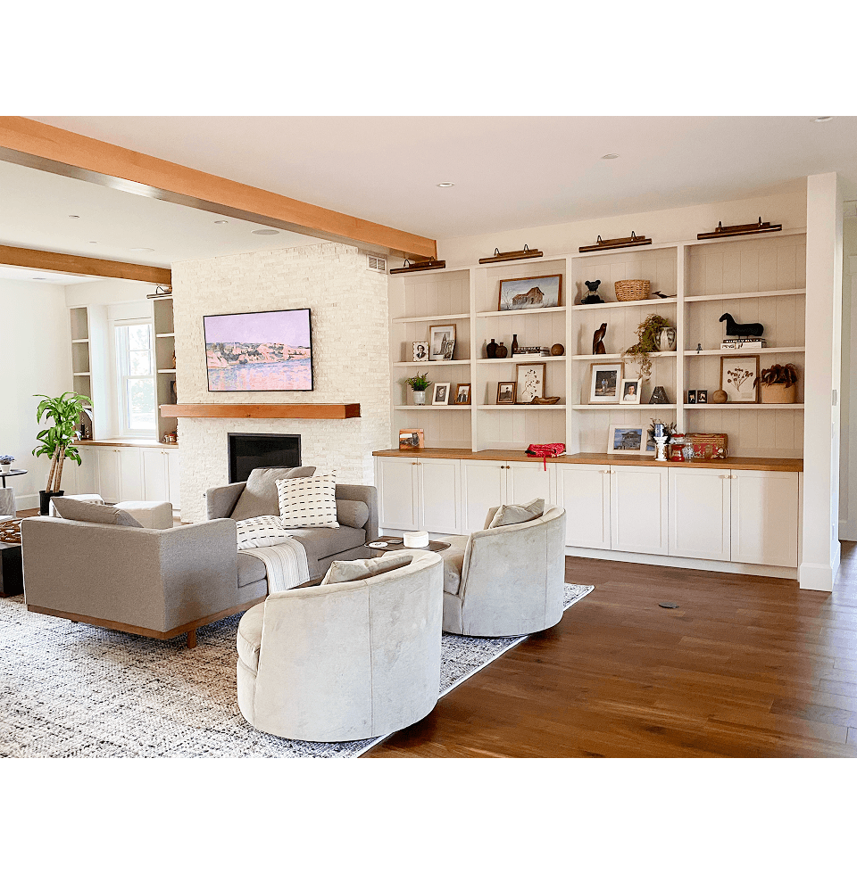 living room with mantle, cabinets, and shelves